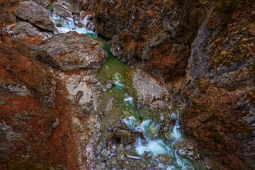 beautiful landscape with a mountain river with small waterfalls in winter day in the canyon.