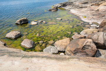 Fototapeta na wymiar Coastal view of Porkkalanniemi, stones in the water and Gulf of Finland, Kirkkonummi, Finland