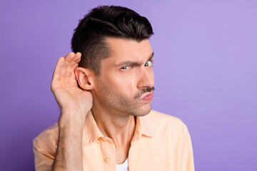 Photo of curious evil guy arm ear eavesdropping listen wear beige shirt isolated purple color...