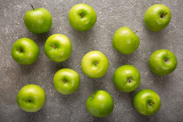 ripe green apples on gray concrete, top view