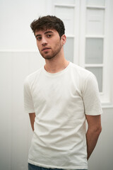 Fototapeta premium young Spanish boy stretching as the day begins in a brightly lit room