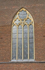 Obraz premium A stained-glass arched window on a church. Saint Walburga catholic church in Amby, Maastricht, The Netherlands.