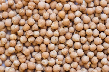 Background of dry chickpeas of lamb or Turkish peas close-up. The texture of the dried chickpeas or garbanzo chickpeas