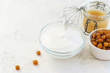 Whipped aquafaba with boiled chickpeas on a light table.