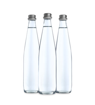 Glass bottles with soda water on white background