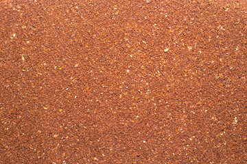 Background of ground insoluble coffee close-up. Texture of ground coffee