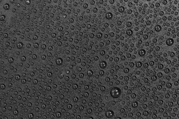 Water drops on black background texture. Dark backdrop glass covered with drops of water. gray bubbles in water