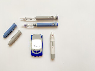 Insulin short, long, glucose meter, test strips and finger piercing pen on a white isolated background. Set for diabetics with mock up