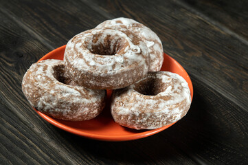 Homemade round gingerbread cookies with icing in a orange plate. Idea for a delicious breakfast or dinner. Top view