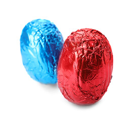 Chocolate eggs wrapped in bright foil on white background