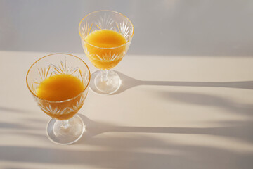 Luxury vintage crystal glass with orange juice on the white table
