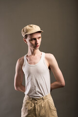 Androgyn young man in men outfit indoors. Studio shot