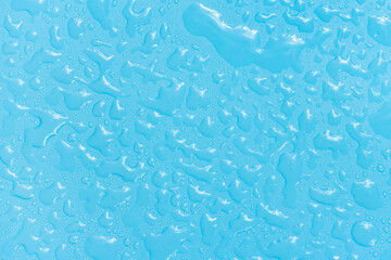 Water drops on blue background texture. Backdrop glass covered with drops of water. bubbles in water