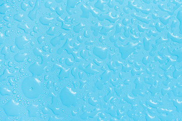 Water drops on blue background texture. Backdrop glass covered with drops of water. bubbles in water