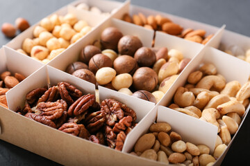 Different grade of nuts in a box on a dark background