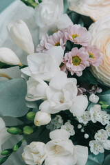 Bouquet of beautiful flowers: white roses, wildflowers, eucalyptus. Flat lay spring pattern background.