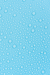 Water drops on blue background texture. Backdrop glass covered with drops of water. bubbles in water
