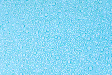 Water drops on blue background texture. Backdrop glass covered with drops of water. bubbles in water