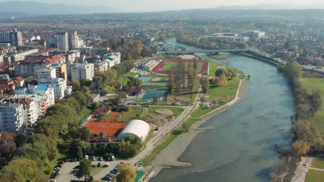 Aerial dolly shot backing away from the city of Kraljevo in central Serbia.