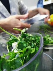 Female hands chopped parsley, isolated on white