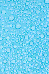 Water drops on blue background texture. Backdrop glass covered with drops of water. bubbles in water