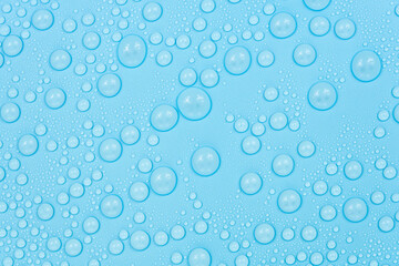 Fototapeta na wymiar Water drops on blue background texture. Backdrop glass covered with drops of water. bubbles in water