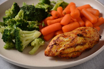 Grilled chicken fillet and vegetables broccoli and carrots boiled