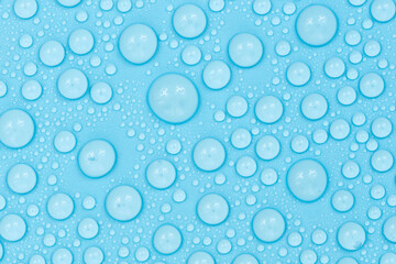 Water drops on blue background texture. Backdrop glass covered with drops of water. bubbles in water