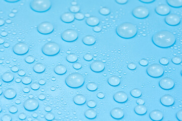 Water drops on blue background texture. Backdrop glass covered with drops of water. bubbles in water
