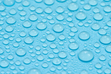 Water drops on blue background texture. Backdrop glass covered with drops of water. bubbles in water