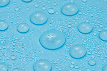 Water drops on blue background texture. Backdrop glass covered with drops of water. bubbles in water