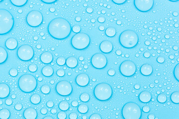 Water drops on blue background texture. Backdrop glass covered with drops of water. bubbles in water