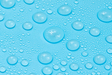 Water drops on blue background texture. Backdrop glass covered with drops of water. bubbles in water