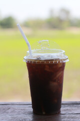 Iced americano coffee with ice on table at cafe.