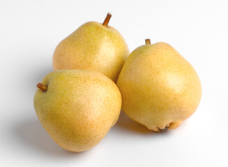 Three yellow pears on white background.