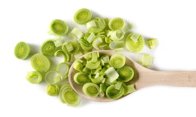 Chopped leek slices pile with wooden spoon isolated on white background, top view