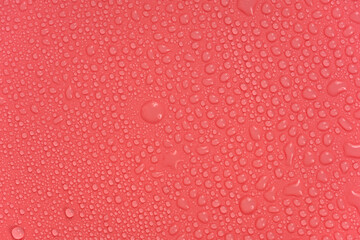 Water drops on red background texture. backdrop glass covered with drops of water.  bubbles in water