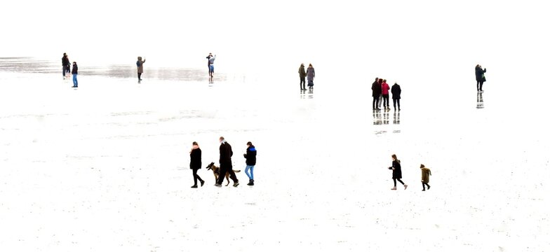 Abstract picture of people walking on a beach