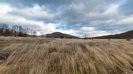 Landscape of the Lozoya reservoir in a cloudy and windy day