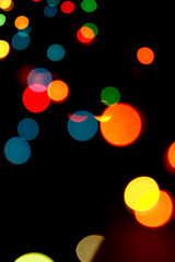 Colorful shiny bokeh lights. New year celebration lights. Cell phone wallpaper. Story background.