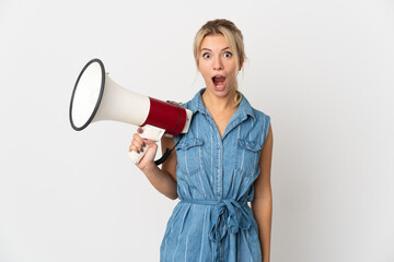 Young Russian woman isolated on white background holding a megaphone and with surprise expression