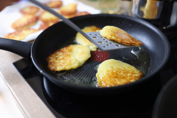 Closeup of fried potato pancakes in frying pan