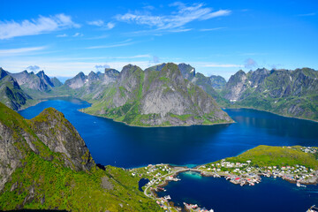 Naklejka na ściany i meble Stunning view point of mountains and blue sea at Reinebringen, Lofoten islands. Scenery of Reine fishing village. One of most popular hiking trails in North of Norway. Nature background