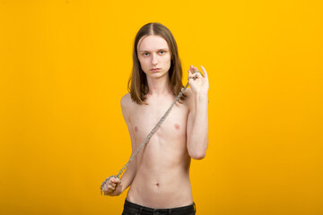 Androgyn young man in men outfit indoors. Studio shot