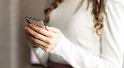 Cropped image of teenage girl using mobile phone