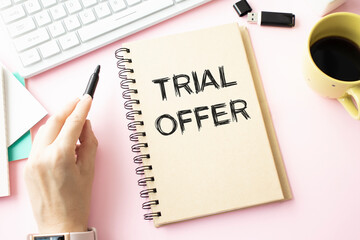 Text for writing words TRIAL OFFER. Business concept or product service offered free of charge to try to give feedback, ON PINK BACKGROUND ON WHITE PAPER