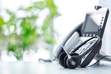Headset headphones telephone with microphone on desk in call center