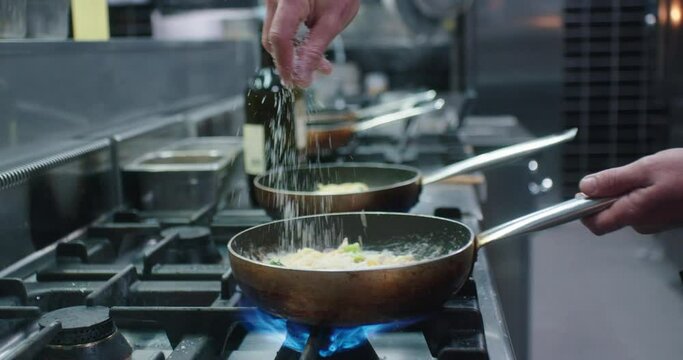 Spreading cheese on a pasta dish