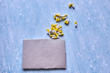 yellow pills. on blue background. vitamins. pills from virus. copy space. medicine concept. place for text on vintage paper