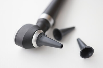 Closeup of otorhinolaryngologist otoscope tool on white background